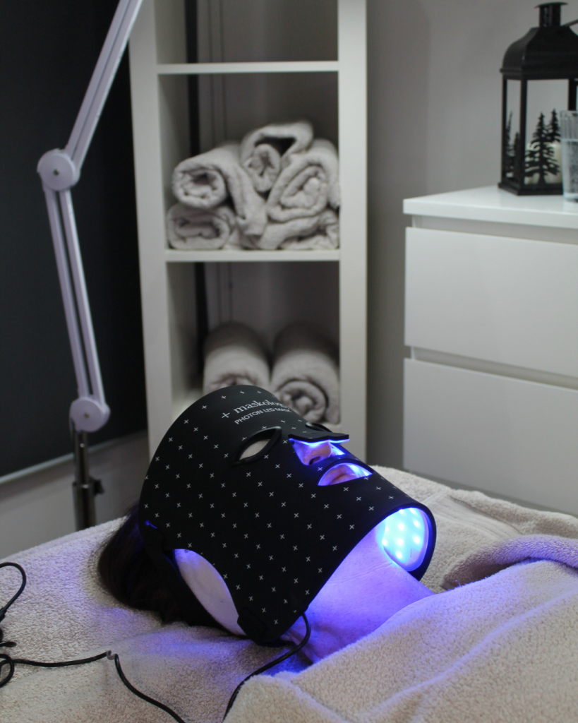 Client receiving a Maskology LED treatment in a salon